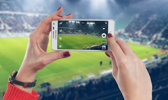 Auf einem Smartphone wird ein Fußballspiel angezeigt. Symbolbild für die Gefahren von Livestreams.