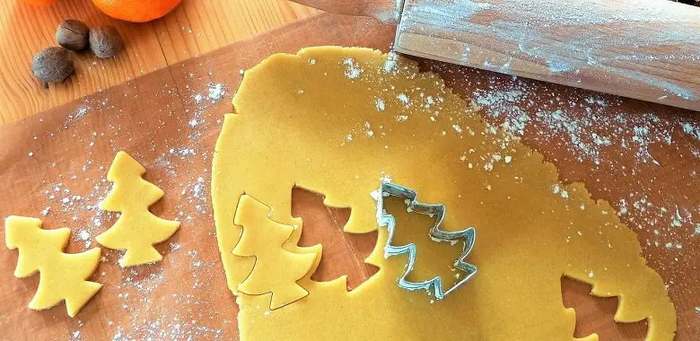 Ein Teig mit Formen und ausgestochenen Plätzchen. Symbolbild für den Tipp für gutes Backen von Plätzchen.